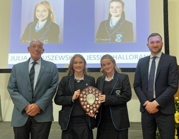 Julia Babuszewska and Jessica Halloran collect the Stuart Shield for recognition to the school community